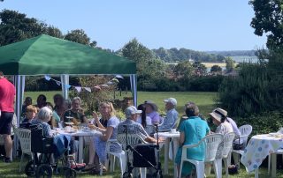 Everyone enjoying the view and the cream tea at Highlands Summer party